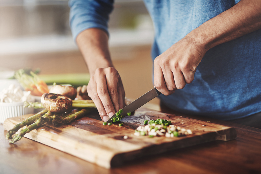 Hands chopping vegetables